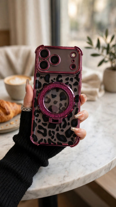 Leopard Ring-Stand Case in Burgundy held at a cafe table